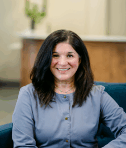 Smiling dental hygienist in a professional setting, representing the dedicated team at Progressive Dental Care, focused on patient comfort and comprehensive dental services.