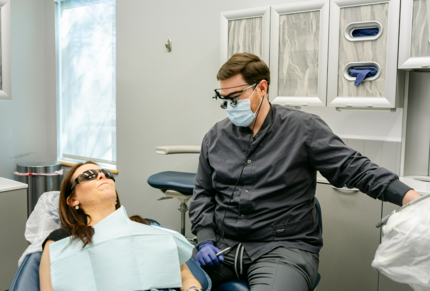 Dentist consulting with a patient about healthy gums and teeth cleaning at Progressive Dental Care in South Portland ME.